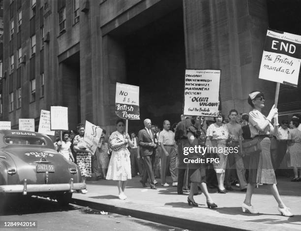 Palestine sympathisers holding placards on a picket outside the British Building at the Rockefeller Centre in New York City, New York, August 1949....