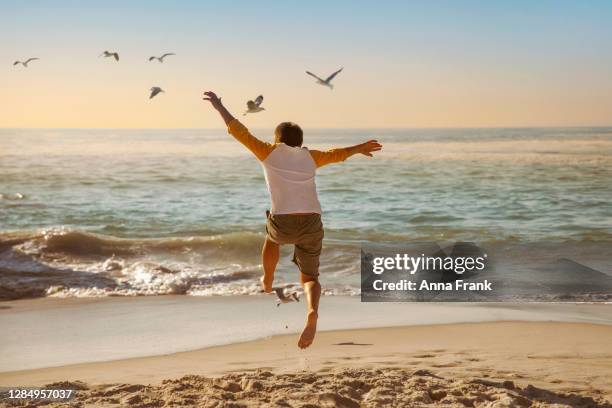 jumping for joy - barefoot teen boys stock pictures, royalty-free photos & images