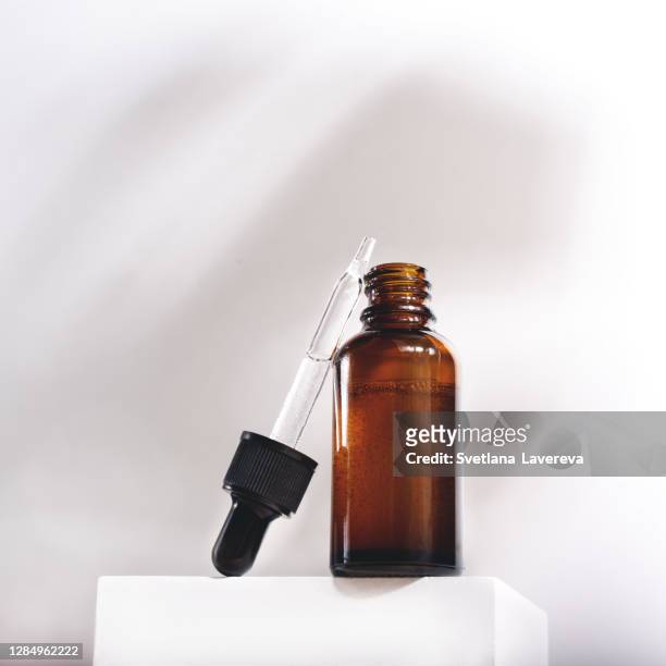 serum glass bottle with pipette on grey background. - serum sample stock pictures, royalty-free photos & images