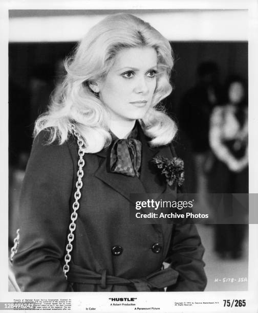 Catherine Deneuve wearing coat in a scene from the film 'Hustle', 1975.