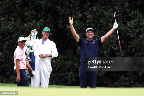 Jon Rahm of Spain celebrates with Rickie Fowler of the United States after skipping in for a hole in one on the 16th during a practice round prior to...