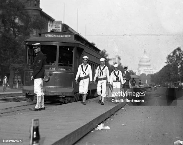 Sailors from the President's yacht Mayflower on guard duty at one of the street car intersections on Pennsylvania Avenue.