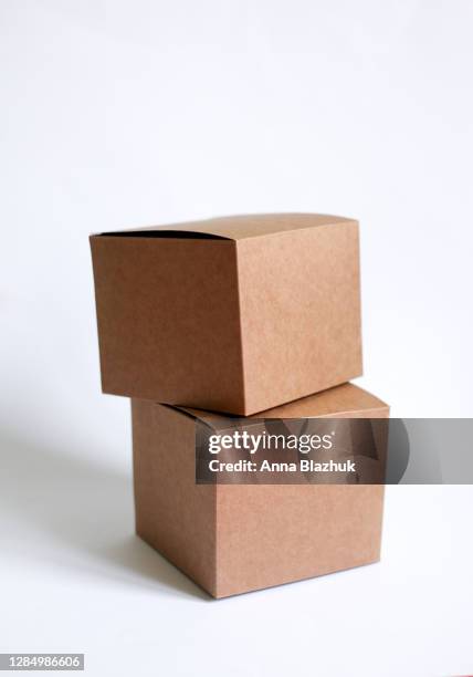 stack of two cardboard boxes against white background, vertical picture - big brown stock pictures, royalty-free photos & images