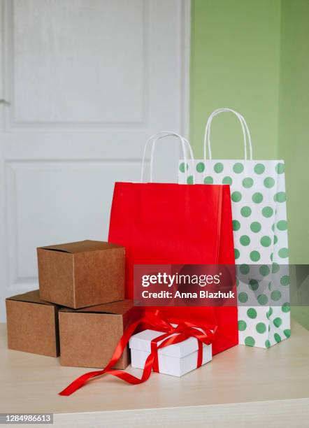 paper shopping bags and boxes at home. concept of black friday, cyber monday, online shopping, gifts and packages. - cyber monday stock pictures, royalty-free photos & images