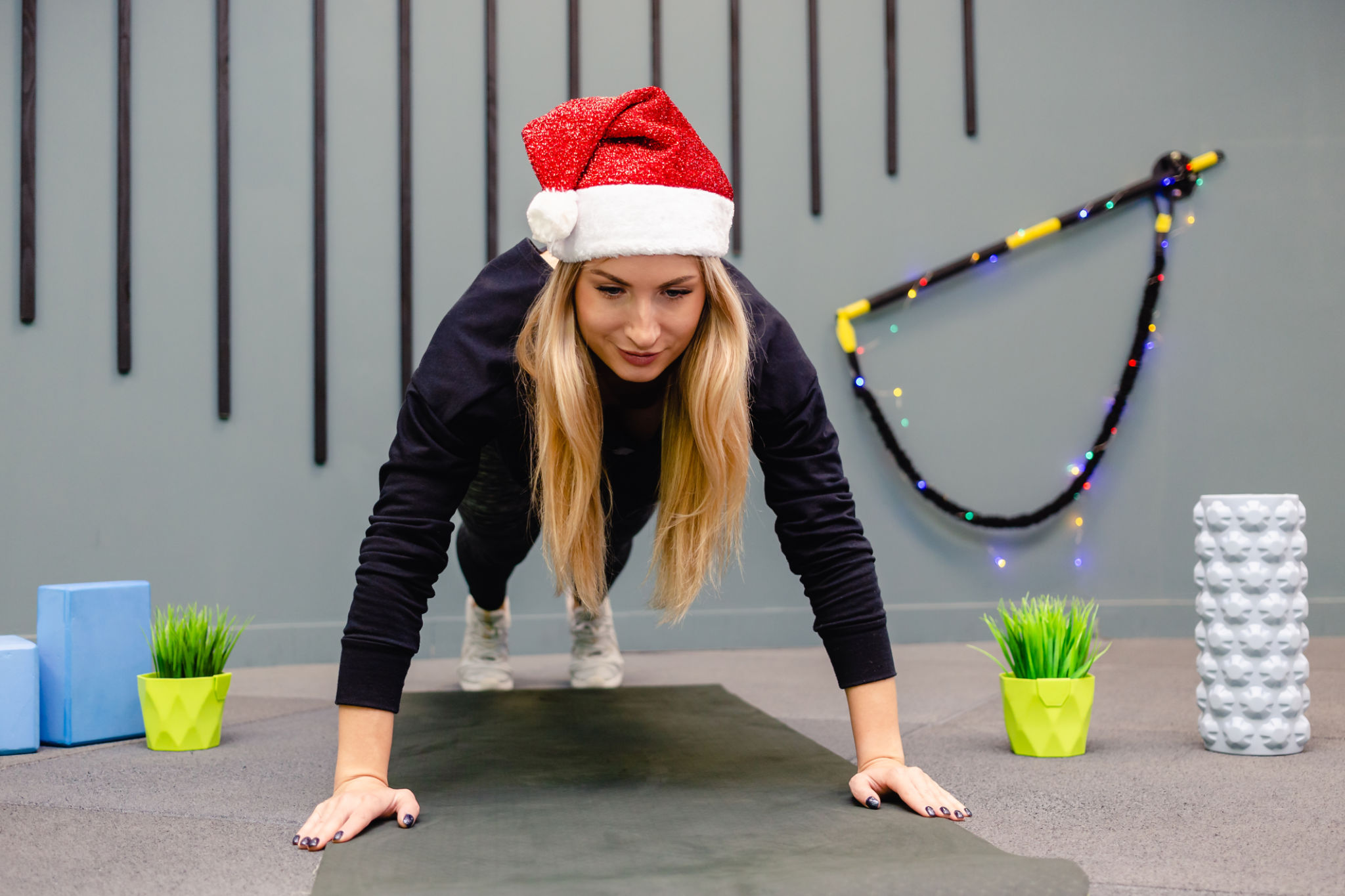Girl in Santa Claus hat in gym Girl in Santa Claus hat in gym