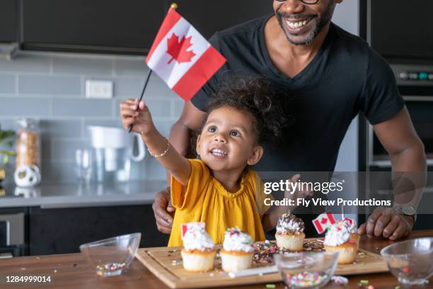 adorable preschool age girl and father celebrating canada day at home - canada day people stock pictures, royalty-free photos & images