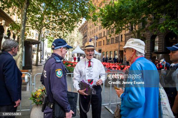 Police officer is seen talking to a protestor behind a barricade at the invite-only official Remembrance Day service in Martin Place on November 11,...