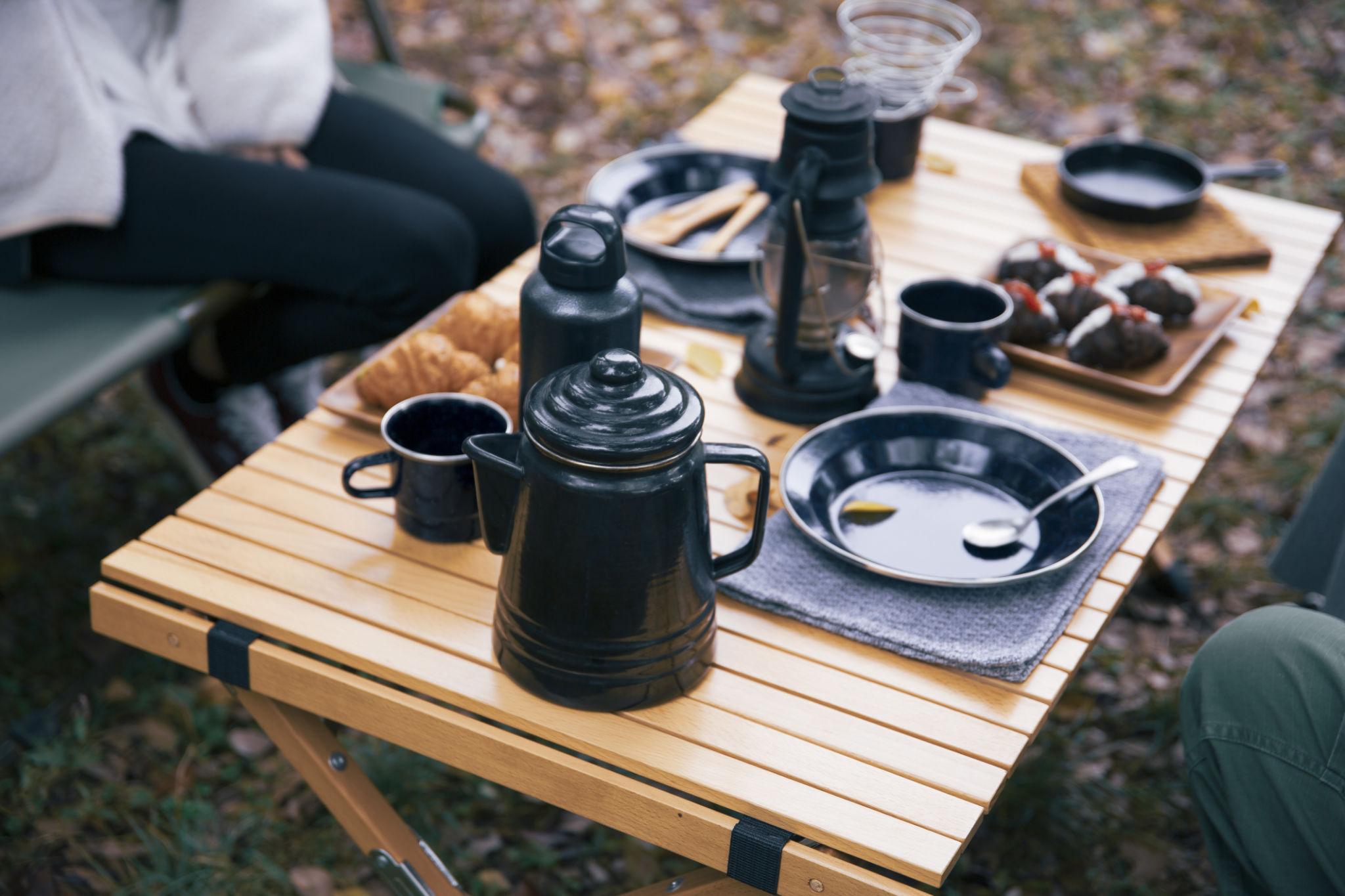 Image photo of women having lunch at a campsite Image photo of women having lunch at a campsite