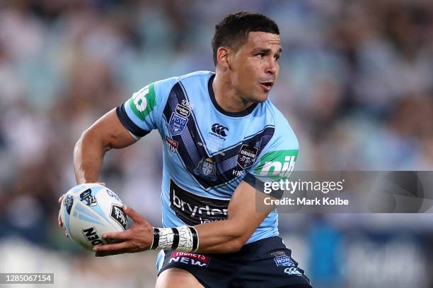 Cody Walker of the Blues offloads the ball during game two of the 2020 State of Origin series between the New South Wales Blues and the Queensland...