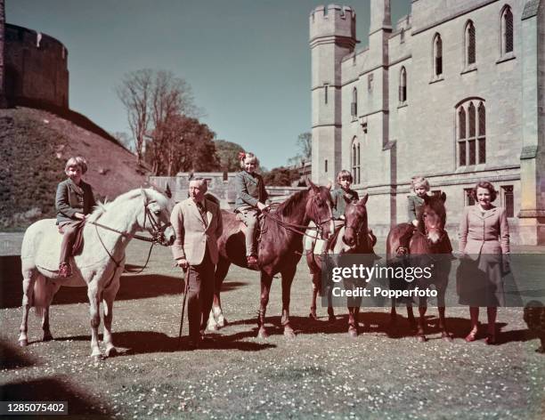 Bernard Fitzalan-Howard, 16th Duke of Norfolk posed with his wife Lavinia Fitzalan-Howard, Duchess of Norfolk and their four daughters, Anne, Mary,...