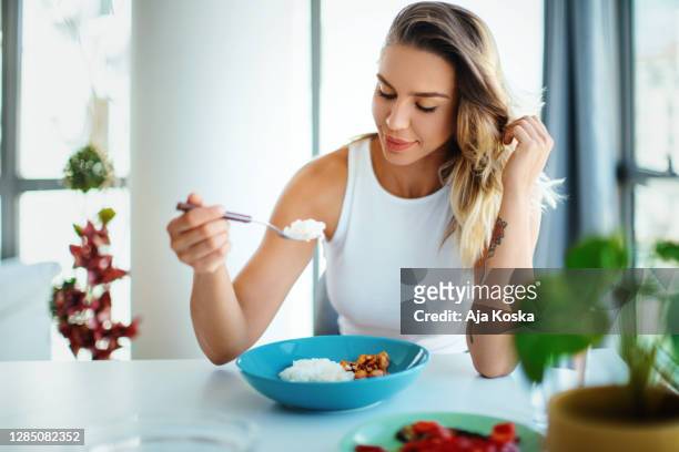 young woman eating lunch alone at the restaurant. - low carb stock pictures, royalty-free photos & images