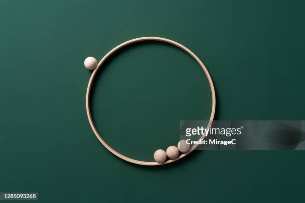 spheres orbiting rings - exclusion concept stock pictures, royalty-free photos & images