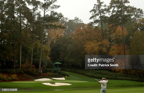 Rickie Fowler of the United States looks on after a shot on the 12th hole during a practice round prior to the Masters at Augusta National Golf Club...