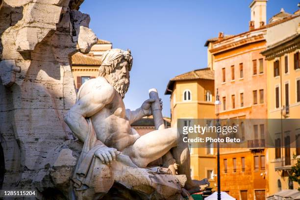 a detailed glimpse of the fountain of the four rivers in piazza navona in the historic and baroque heart of rome - fountain of the four rivers stock pictures, royalty-free photos & images