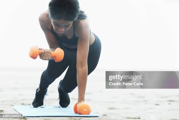 woman weight training on beach - coastal feature stock pictures, royalty-free photos & images