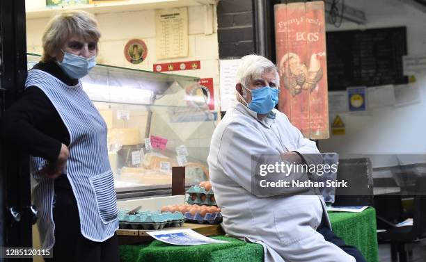 Market stall owners sit outside their stalls in Leek Market on November 11, 2020 in Leek, England. The Booksellers Association has called on the...
