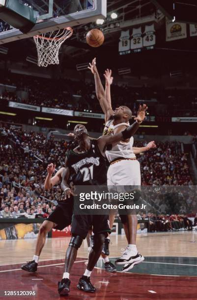 Vin Baker, Power Forward for the Seattle SuperSonics shoots for the basket above Kevin Garnett of the Minnesota Timberwolves during their NBA Midwest...