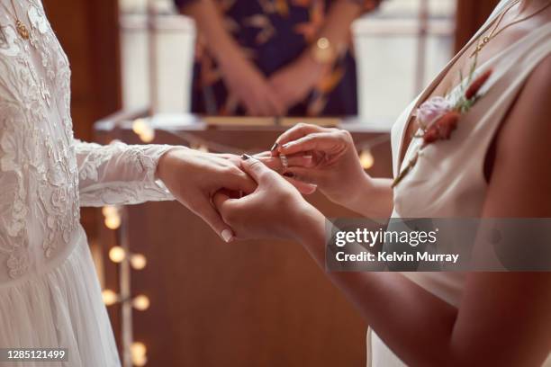 lesbian same sex wedding, ring exchange - civil partnership stock pictures, royalty-free photos & images