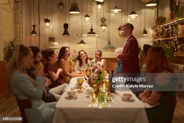 lesbian same sex wedding and friends having dinner party - dinner reception for the wedding of lee radziwill and herb ross stockfoto's en -beelden