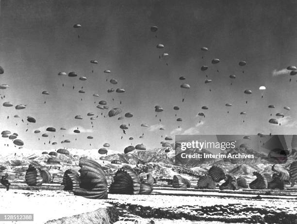 During the Korean War, soldiers and equipment are parachuted in an operation by United Nations airborne units, 1951.