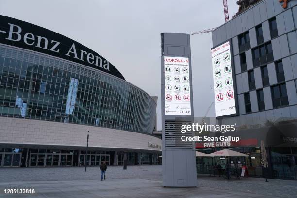 Man walks past the Mercedes-Benz Arena events venue closed under a four-week semi-lockdown during the second wave of the coronavirus pandemic on...