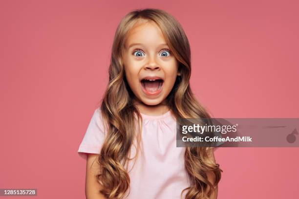 funny girl on pink background - disbelief stock pictures, royalty-free photos & images