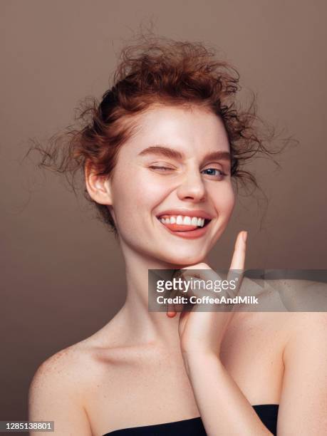 portrait of beautiful happy girl with red hair and shaving foam on her face - winking eye stock pictures, royalty-free photos & images