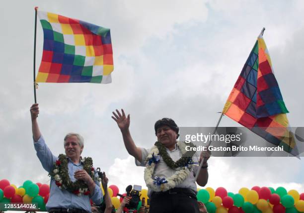 Former president of Bolivia Evo Morales and former vice-president Alvaro García Linera wave a wiphala flag and greet supporters on their arrival...