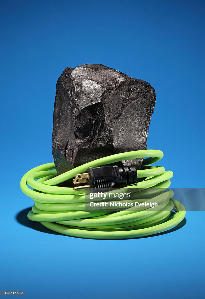 Electrical cord wrapped on a black coal