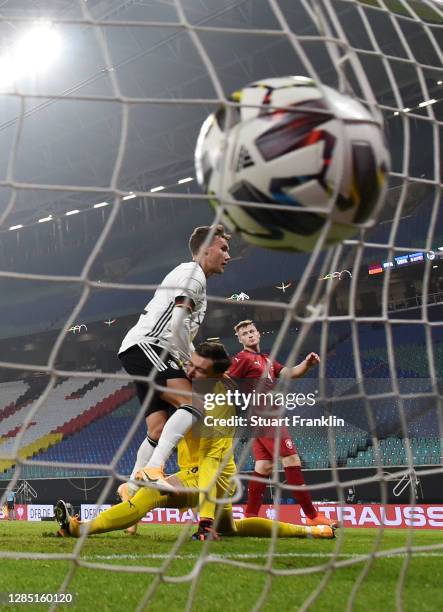 Luca Waldschmidt of Germany hits goalkeeper Jiri Pavlenka of Czech Republic after scoring his team's first goal during the international friendly...