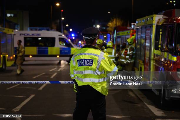 Police officers secure the cordon around Edmonton Green police station, following an incident involving a car colliding with the front doors of the...