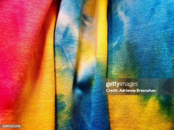 draped tie dyed fabrics - tie dye stockfoto's en -beelden