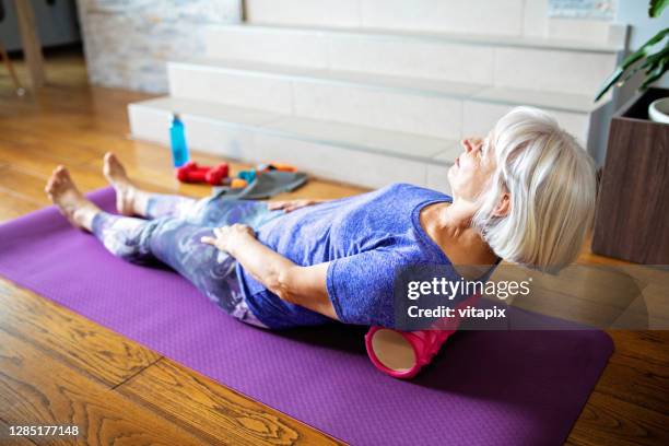 foam roller massage for lower back pain - sciatic nerve stock pictures, royalty-free photos & images