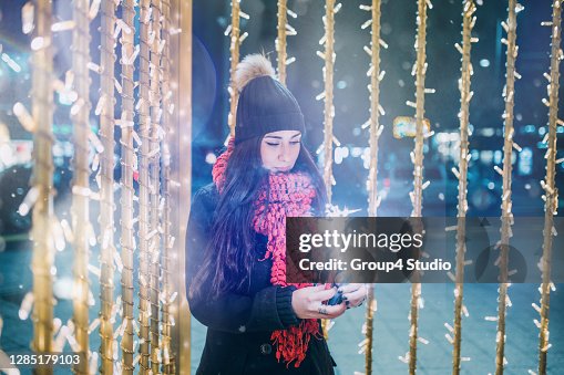 Woman with big sparklers enjoying New Year eve Woman with big sparklers enjoying New Year eve
