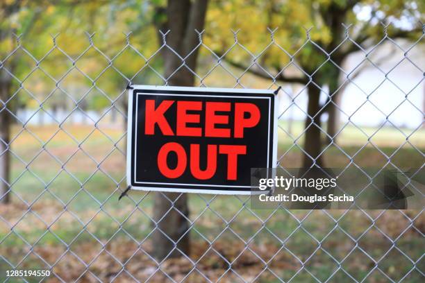 keep out sign posted on a chain link fence - keep out sign stock pictures, royalty-free photos & images