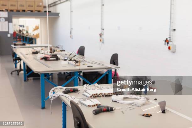 empty desks on a factory production line - trestle stock pictures, royalty-free photos & images