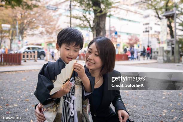 young mother and her son in 'hakama' traditional outfit for shichi go san life event - shichi go san stock pictures, royalty-free photos & images