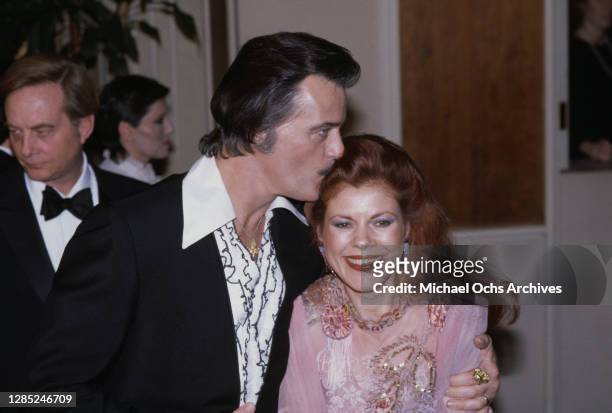 American actor Robert Goulet kissing his wife, Yugoslavian-born writer and artist Vera Novak on the head during 40th Annual Golden Globe Awards, held...