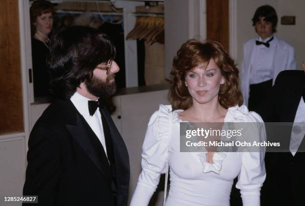 American actress Marilu Henner and a male guest attend the 40th Annual Golden Globe Awards, held at the Beverly Hilton Hotel in Beverly Hills,...