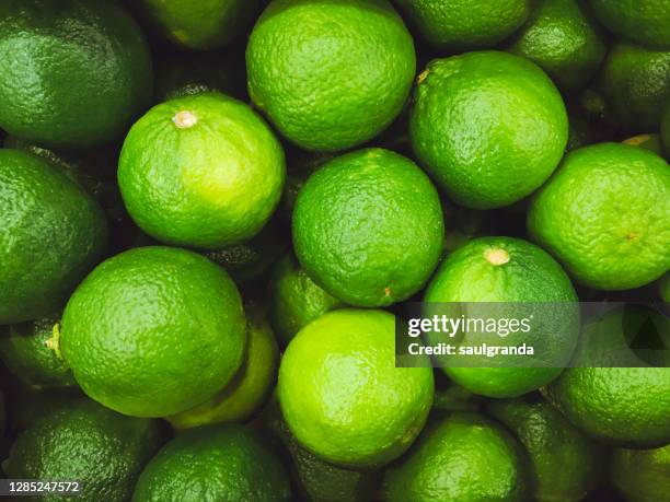 full frame shot of limes from above - lime stock pictures, royalty-free photos & images