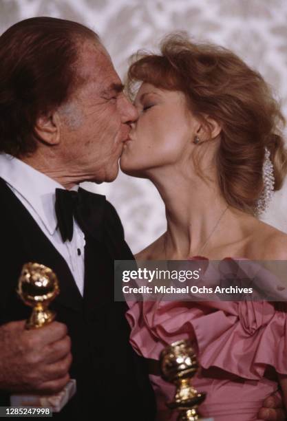 American actor Lionel Stander kisses American actress Shelley Long at the 40th Annual Golden Globe Awards, held at the Beverly Hilton Hotel in...