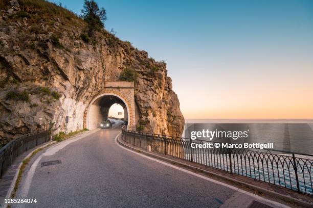 car driving in a tunnel along amalfi coast, italy - túnel de carretera fotografías e imágenes de stock