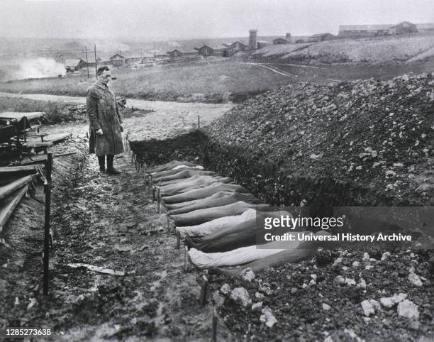 Chaplain T.R. White standing before Mass Burial Site for Soldiers that died while at Red Cross Hospital no. 114, Fleury sur Aisne, Meuse, France,...