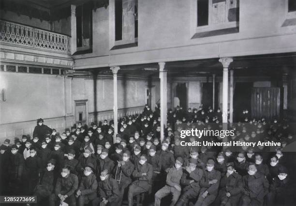 Patients at Moving Picture Show wearing Masks because of Influenza Epidemic, U.S. Army Hospital No. 30, Royat, France, 1914-1918.