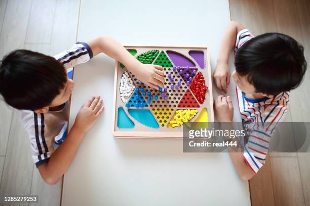 kid playing chinese checkers - playing board games stock pictures, royalty-free photos & images