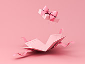 Blank sweet pink pastel color present box or open gift box with pink ribbon and bow isolated on pink background with shadow minimal concept