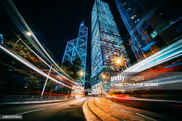 traffic trails in financial district - central stock pictures, royalty-free photos & images