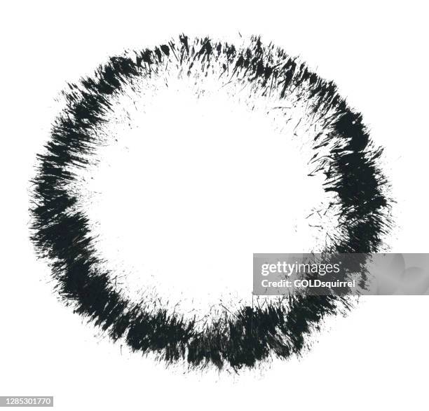 circle outlined with sharp densely arranged lines hand-painted in black paint and a very hard brush on white paper background - vector illustration with a grassy structure facing the inside of a round object - bubble with uneven edges - torn edge frame stock illustrations