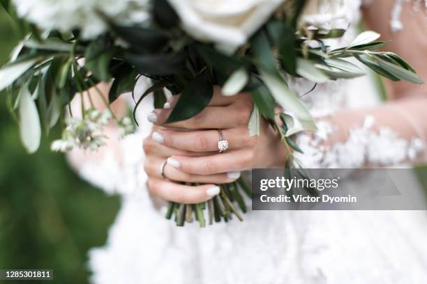 fresh green bouquet in the bride's hands - flowers royalty free stock pictures, royalty-free photos & images