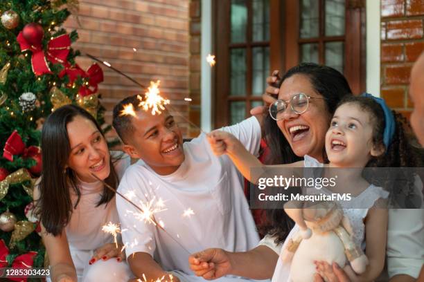 family celebrating new year together - family new year's eve stock pictures, royalty-free photos & images